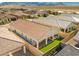 An aerial of the backyard features a covered patio, artificial turf, desert landscaping, and a private oasis at 10972 Nicholas Jay Ave, Las Vegas, NV 89166