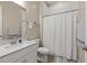 Clean, well-lit bathroom with a granite sink, tiled shower and modern design at 10972 Nicholas Jay Ave, Las Vegas, NV 89166