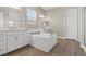 Bright and modern bathroom featuring a luxurious soaking tub and double vanities at 10972 Nicholas Jay Ave, Las Vegas, NV 89166