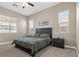 Comfortable bedroom featuring soft carpet, a picture window, and neutral wall colors at 10972 Nicholas Jay Ave, Las Vegas, NV 89166