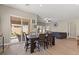 Dining room featuring an outdoor view, wood floors, and a dining table with seating at 10972 Nicholas Jay Ave, Las Vegas, NV 89166