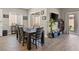 A bright dining room area featuring hardwood floors, table seating, and sliding glass doors to backyard at 10972 Nicholas Jay Ave, Las Vegas, NV 89166