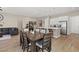 Bright dining room featuring an open floor plan with wood floors, and a dining table with seating at 10972 Nicholas Jay Ave, Las Vegas, NV 89166