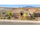 Beautiful aerial view of a single-story home with desert landscaping, a two-car garage, and a mountain backdrop at 10972 Nicholas Jay Ave, Las Vegas, NV 89166