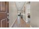 Spacious hallway with wood-look tile flooring, neutral paint, and a view into the living area at 10972 Nicholas Jay Ave, Las Vegas, NV 89166