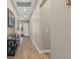 Neutral hallway with wood-look tile flooring, light-colored walls, and decor on a console table at 10972 Nicholas Jay Ave, Las Vegas, NV 89166