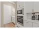 Bright kitchen featuring stainless steel appliances, white cabinets, and white countertop space at 10972 Nicholas Jay Ave, Las Vegas, NV 89166