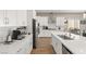 Bright kitchen featuring white cabinets, stainless steel appliances, and a kitchen island with seating at 10972 Nicholas Jay Ave, Las Vegas, NV 89166