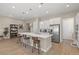 Bright kitchen featuring a kitchen island with bar seating, white cabinets, and stainless steel appliances at 10972 Nicholas Jay Ave, Las Vegas, NV 89166