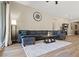 Spacious living room with a sectional couch, area rug, and view to the outside at 10972 Nicholas Jay Ave, Las Vegas, NV 89166
