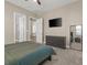 Stylish bedroom with neutral walls, soft carpet, and an ensuite bathroom at 10972 Nicholas Jay Ave, Las Vegas, NV 89166