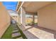 Covered patio with brick pavers, artificial turf, a built-in grill, and ample space for outdoor living at 10972 Nicholas Jay Ave, Las Vegas, NV 89166