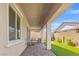 Wide covered patio featuring brick pavers and artificial grass with seating area at 10972 Nicholas Jay Ave, Las Vegas, NV 89166