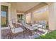 Inviting covered patio with comfortable seating and a view of the well-maintained backyard at 10972 Nicholas Jay Ave, Las Vegas, NV 89166