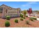 The community entrance sign is stone with lush landscaping, and ornamental bushes, creating a welcoming first impression at 10972 Nicholas Jay Ave, Las Vegas, NV 89166