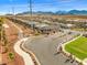 Street view of the neighborhood showcases well-manicured lawns, desert landscaping, and stunning mountain views in the distance at 10972 Nicholas Jay Ave, Las Vegas, NV 89166