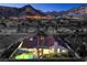Aerial view of a property showcasing a bright swimming pool, well-manicured lawn, and inviting outdoor space at 1144 Calico Ridge Dr, Henderson, NV 89011