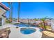 Resort-style backyard boasts a sparkling pool, spa, mature palms and BBQ, ideal for relaxation and entertainment at 1144 Calico Ridge Dr, Henderson, NV 89011