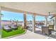 Relaxing covered patio overlooking a beautiful pool, palm trees, and lounge chairs at 1144 Calico Ridge Dr, Henderson, NV 89011