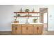 Close up view of bar with wood shelves and cabinets and modern sink at 1144 Calico Ridge Dr, Henderson, NV 89011