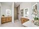 Bright bathroom with double sink vanity, illuminated mirrors, and a luxurious walk-in shower at 1144 Calico Ridge Dr, Henderson, NV 89011
