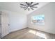 Bright bedroom featuring a large window with views, light wood-look floors, and a ceiling fan at 1144 Calico Ridge Dr, Henderson, NV 89011