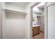 Well-organized walk-in closet with rods, shelves, and a view into the bathroom and vanity at 1144 Calico Ridge Dr, Henderson, NV 89011