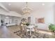 Dining area featuring modern chandelier, sleek table set, and a bar at 1144 Calico Ridge Dr, Henderson, NV 89011