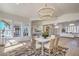 Bright dining room features modern chandelier, large windows, and open floor plan at 1144 Calico Ridge Dr, Henderson, NV 89011