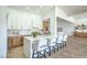 Modern kitchen features stainless steel appliances, island seating, and bright lighting at 1144 Calico Ridge Dr, Henderson, NV 89011