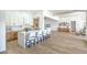 Bright, modern kitchen featuring an island with seating, stainless steel appliances, and white cabinetry at 1144 Calico Ridge Dr, Henderson, NV 89011