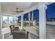 Covered patio with ceiling fan and seating overlooking the lush backyard, creating a perfect outdoor living space at 1144 Calico Ridge Dr, Henderson, NV 89011