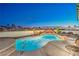 Backyard pool and spa with rock features and mature palms, perfect for outdoor relaxation and entertainment at 1144 Calico Ridge Dr, Henderson, NV 89011