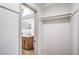 Walk-in closet featuring built-in shelving across from a bathroom with a modern vanity at 1144 Calico Ridge Dr, Henderson, NV 89011