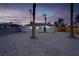 Backyard with palm trees, minimalist landscaping and home with neutral paint at 1209 S 17Th St, Las Vegas, NV 89104