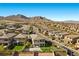 Aerial view of a neighborhood showcasing the home's basketball court and mountain views at 12413 Alpenglow Ct, Las Vegas, NV 89138