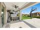 Covered patio with a hot tub, overlooking a spacious backyard with a basketball court at 12413 Alpenglow Ct, Las Vegas, NV 89138
