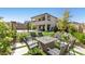 Spacious backyard with well-manicured landscaping, fire pit, basketball court, and covered patio at 12413 Alpenglow Ct, Las Vegas, NV 89138