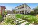 Spacious backyard features artificial grass, a basketball court, covered patio and a balcony at 12413 Alpenglow Ct, Las Vegas, NV 89138