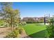 Spacious backyard with synthetic grass, attractive landscaping, and a basketball court at 12413 Alpenglow Ct, Las Vegas, NV 89138