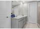 Stylish bathroom features a dual-sink vanity with modern fixtures and a separate shower at 12413 Alpenglow Ct, Las Vegas, NV 89138