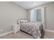 Calm bedroom with neutral colors, soft carpet, and window with natural light at 12413 Alpenglow Ct, Las Vegas, NV 89138