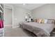 Neutral-toned bedroom with a metal bed frame, shelving unit, and an open door at 12413 Alpenglow Ct, Las Vegas, NV 89138