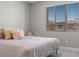 Bright bedroom features a comfortable bed and a window with neighborhood views at 12413 Alpenglow Ct, Las Vegas, NV 89138