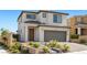 Charming two-story home featuring landscaped front yard, covered entry, and attached two-car garage at 12413 Alpenglow Ct, Las Vegas, NV 89138