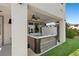 Covered hot tub area adjacent to artificial grass in a modern backyard at 12413 Alpenglow Ct, Las Vegas, NV 89138
