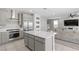Modern kitchen with stainless steel appliances, a large island, and open to the comfortable living area at 12413 Alpenglow Ct, Las Vegas, NV 89138
