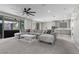 Spacious living room with a plush sectional sofa, connecting seamlessly to the modern kitchen at 12413 Alpenglow Ct, Las Vegas, NV 89138
