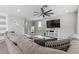 Cozy living room with plush seating, modern decor, and large screen TV perfect for relaxing at 12413 Alpenglow Ct, Las Vegas, NV 89138