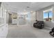Spacious loft with neutral carpet, ample natural light, and cozy seating at 12413 Alpenglow Ct, Las Vegas, NV 89138